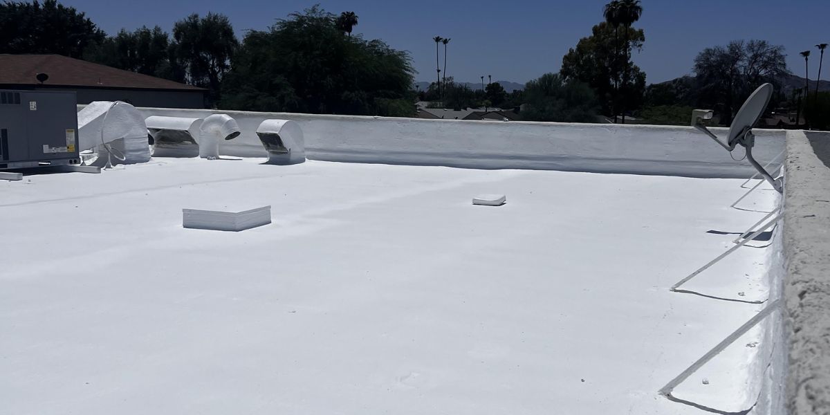 Freshly coated white acrylic flat roof on a commercial building in Arizona.