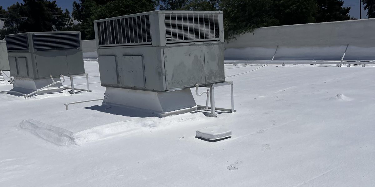 HVAC units on a commercial flat roof with fresh white coating in Arizona.